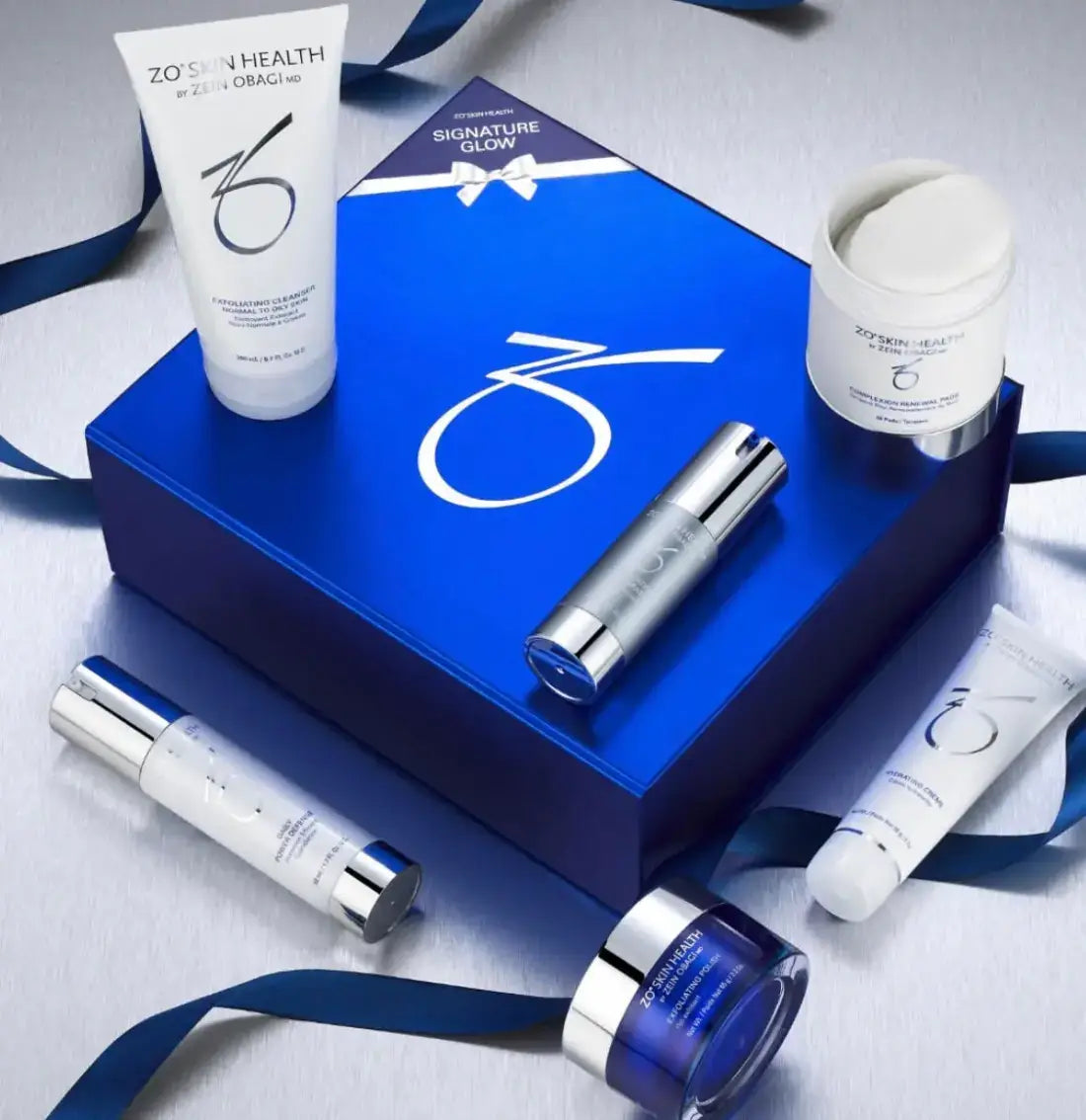 ZO Skin Health Signature Glow Festive Kit with skincare products in a blue box and ribbon.