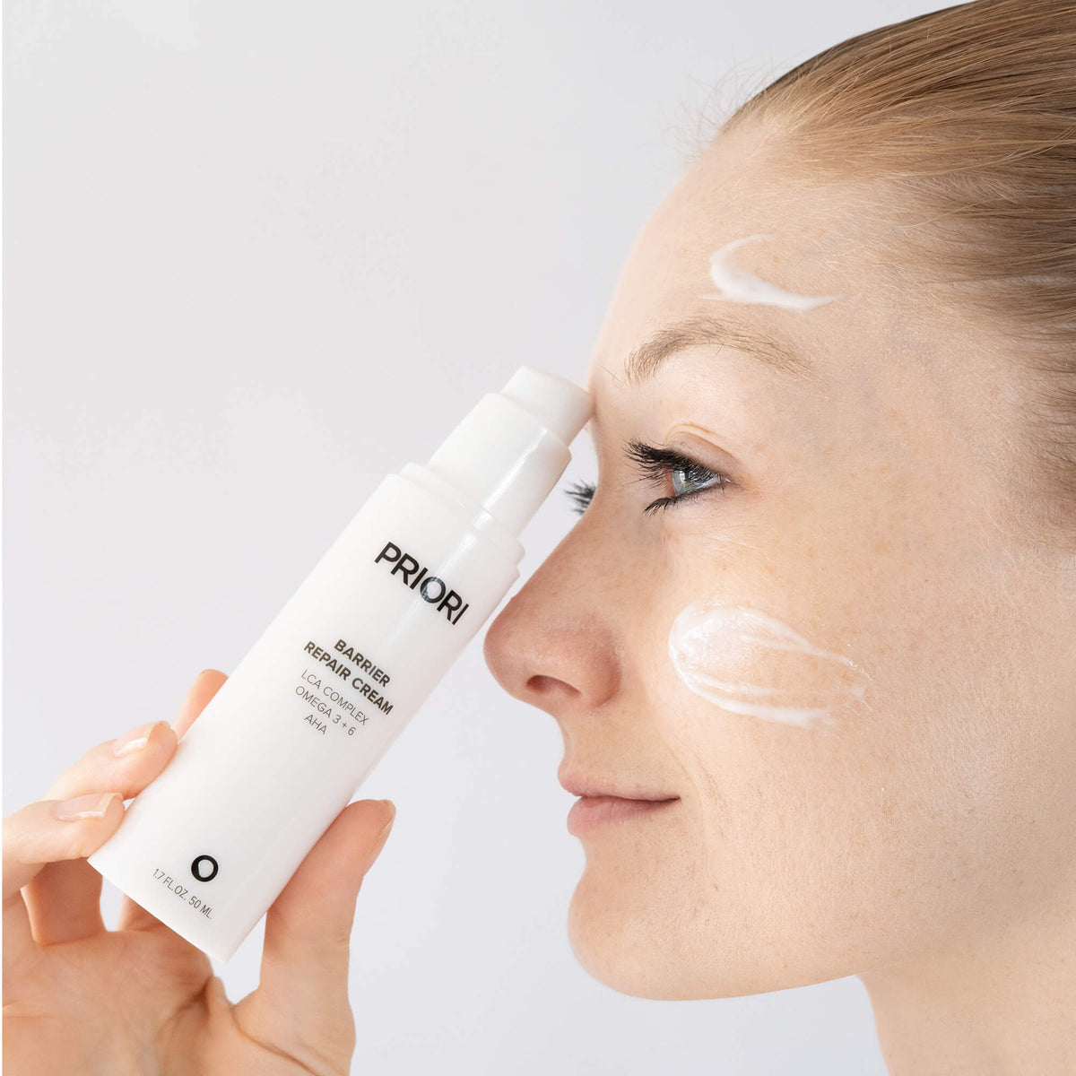 Applying PRIORI LCA Barrier Repair Cream oil-free moisturiser to the face
