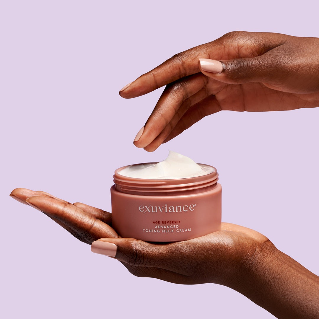 Exuviance AGE REVERSE+ Advanced Toning Neck Cream tube held in hand