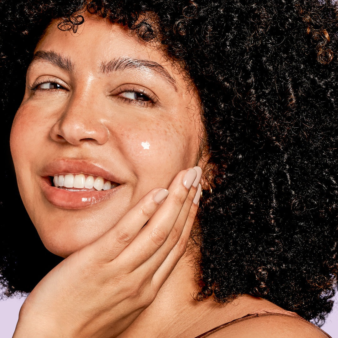 Exuviance AGE REVERSE+ Advanced Total Correct Serum applied to the face