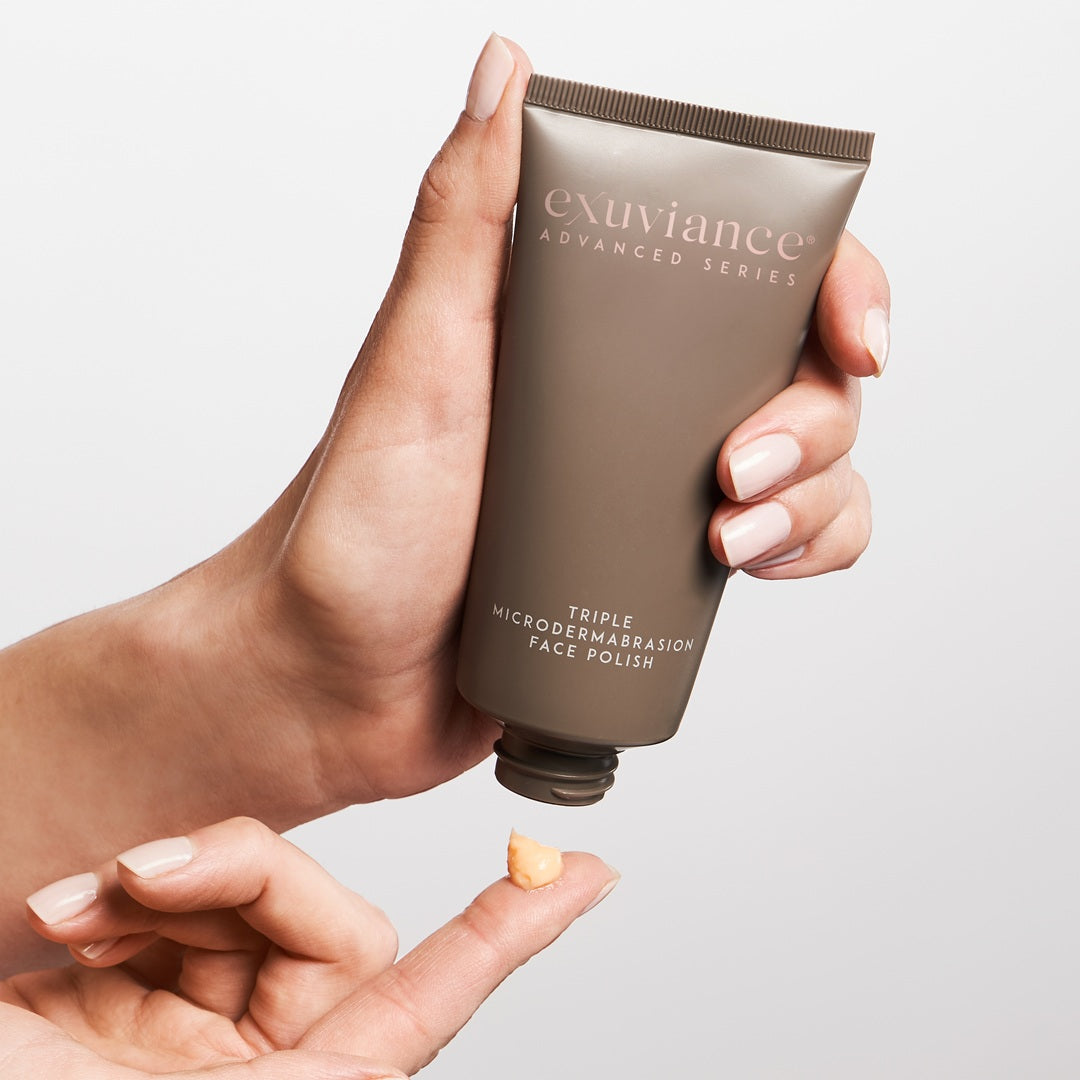 Exuviance Triple Microdermabrasion Face Polish held in hand