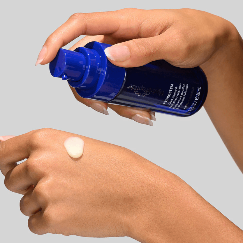 HydroPeptide HydroStem Serum™ being applied to the hand, showcasing its age-defying benefits.