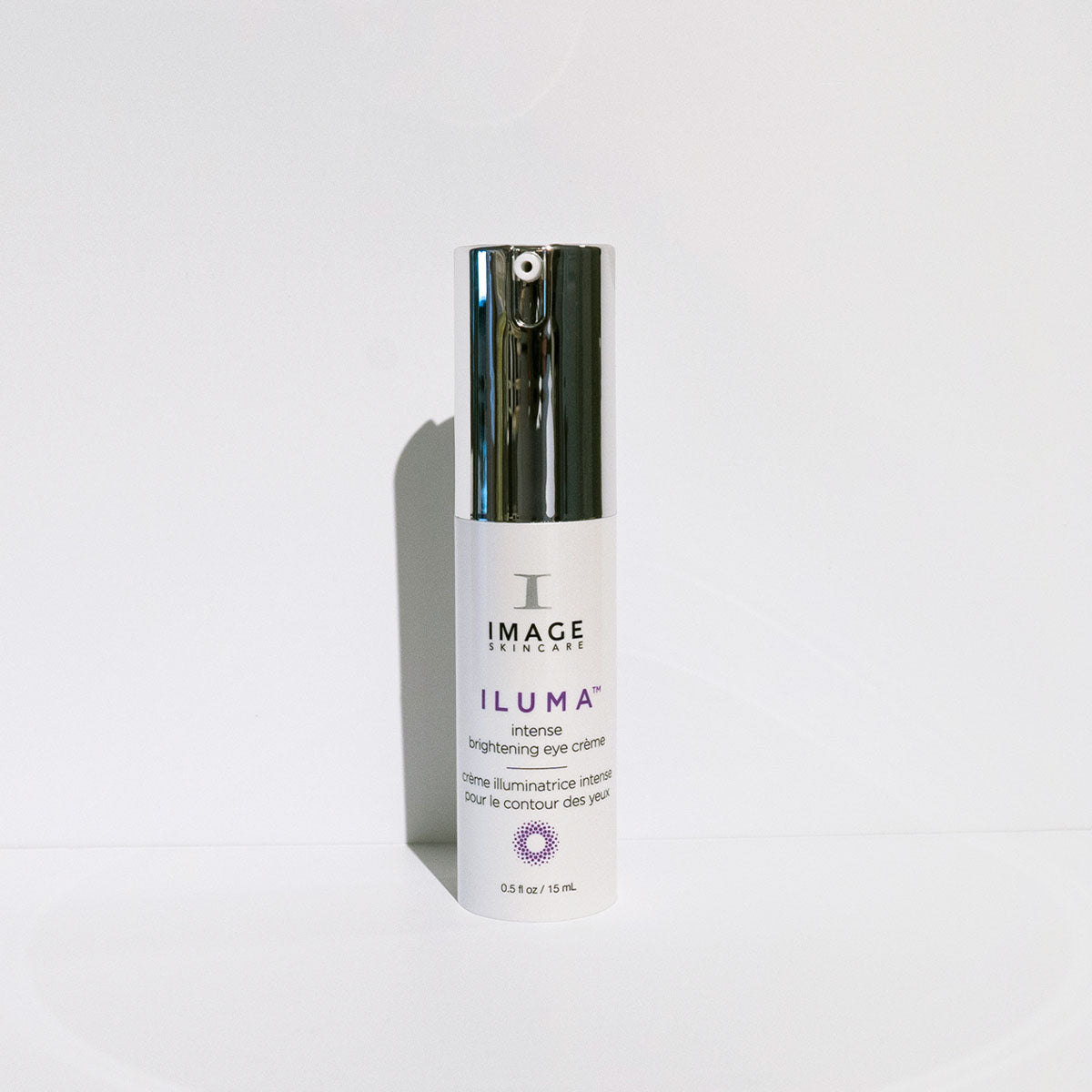 IMAGE Skincare ILUMA Intense Brightening Eye Crème pump on a white surface