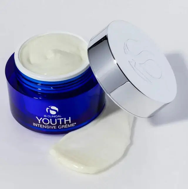 iS Clinical Youth Intensive Crème – Anti-Ageing Peptide Moisturiser 50g / 100g in a blue jar with cream spilled.