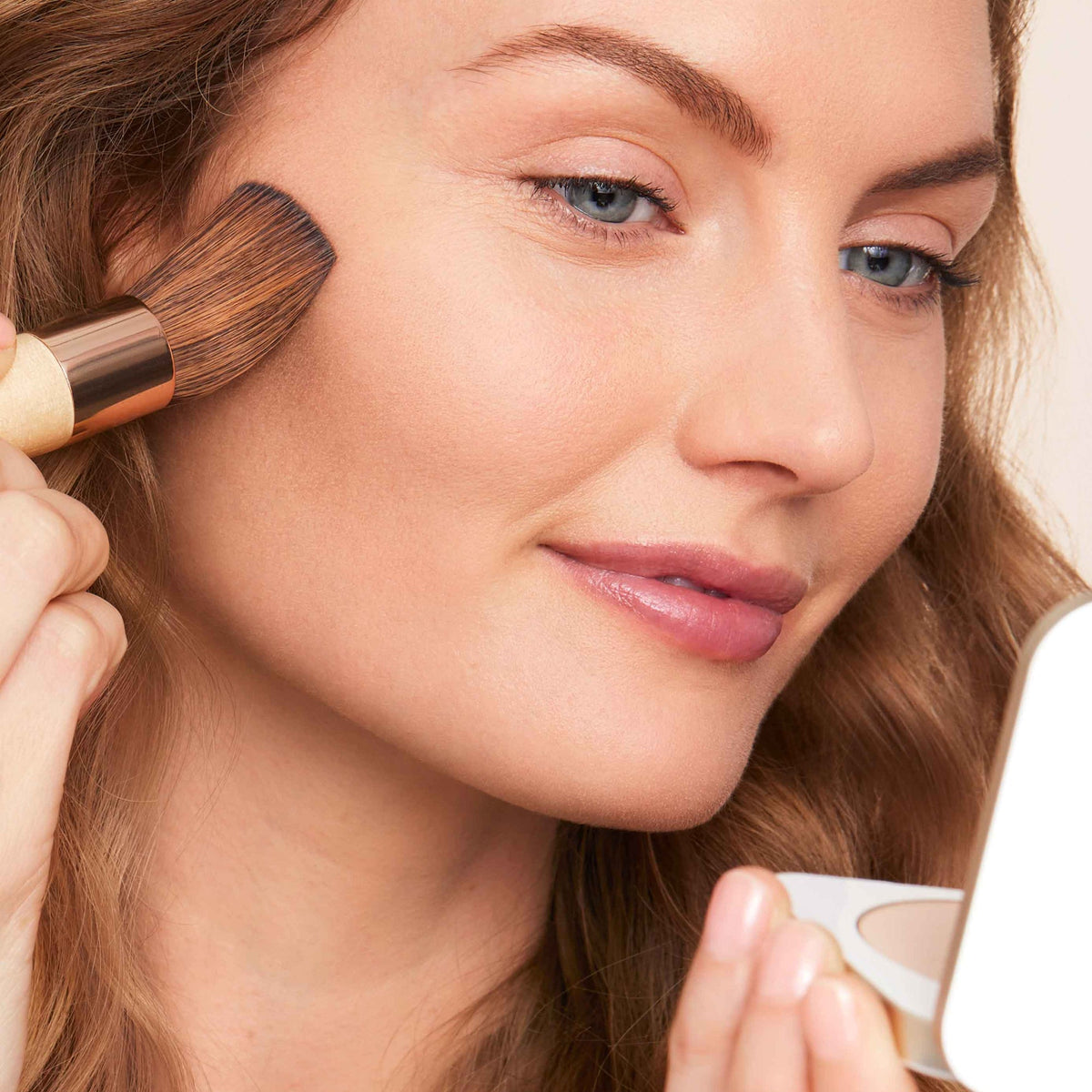 Jane Iredale PurePressed Base Mineral Foundation Refill being applied with a brush for a natural, second-skin finish