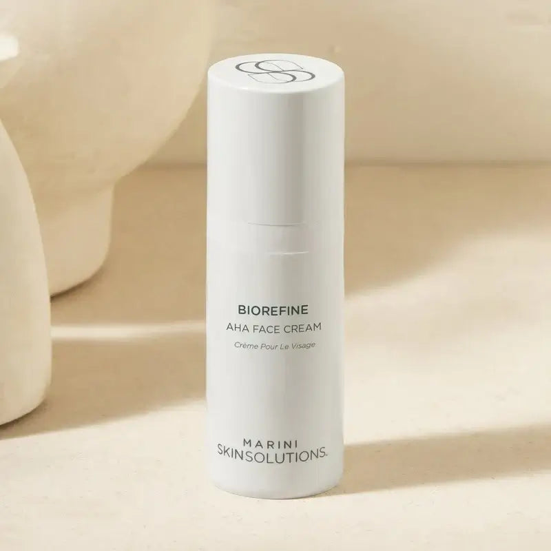 Marini Skin Solutions BioRefine AHA Face Cream in a sleek white bottle on a neutral background.