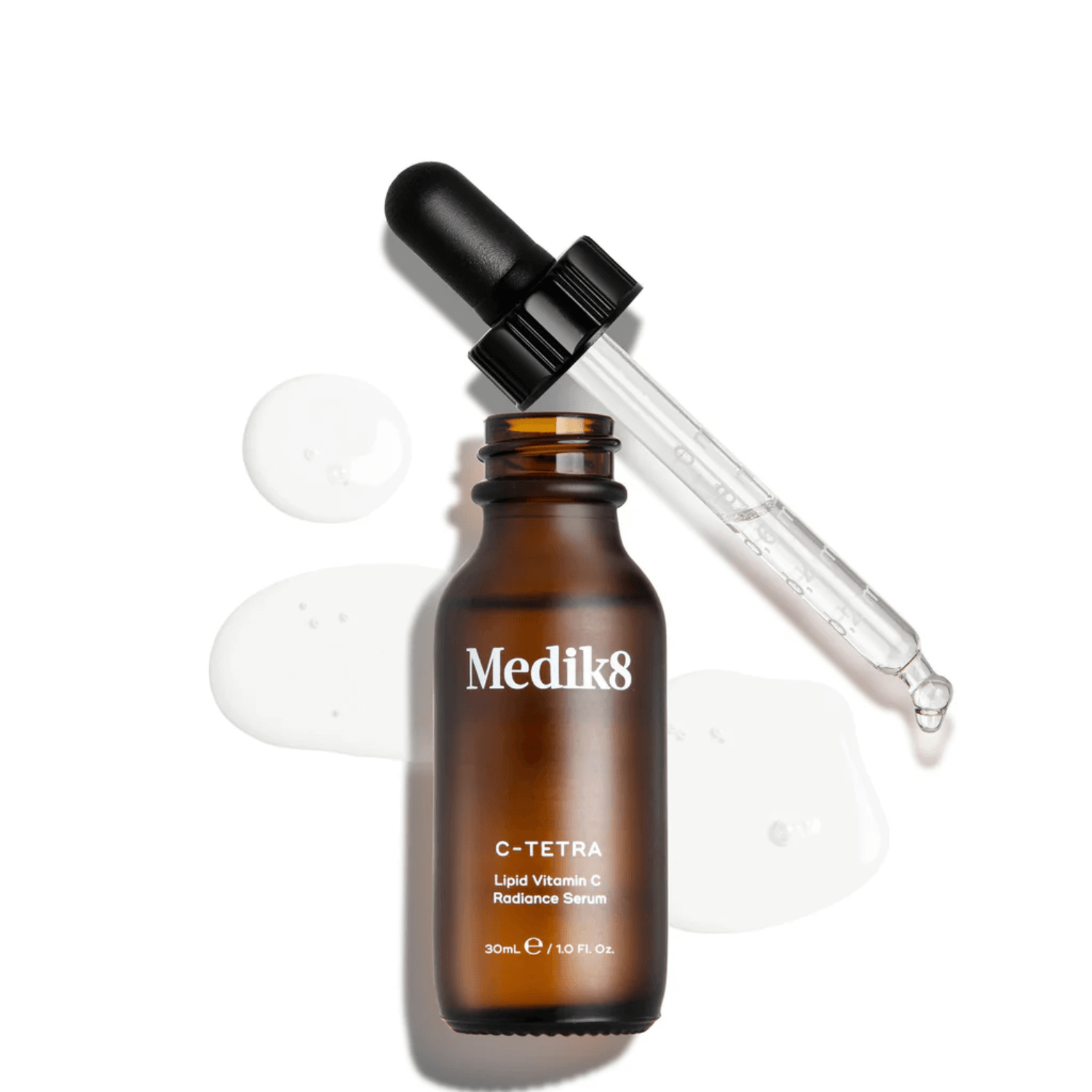 Medik8 C-Tetra vitamin C serum in amber bottle with dropper and oil drops