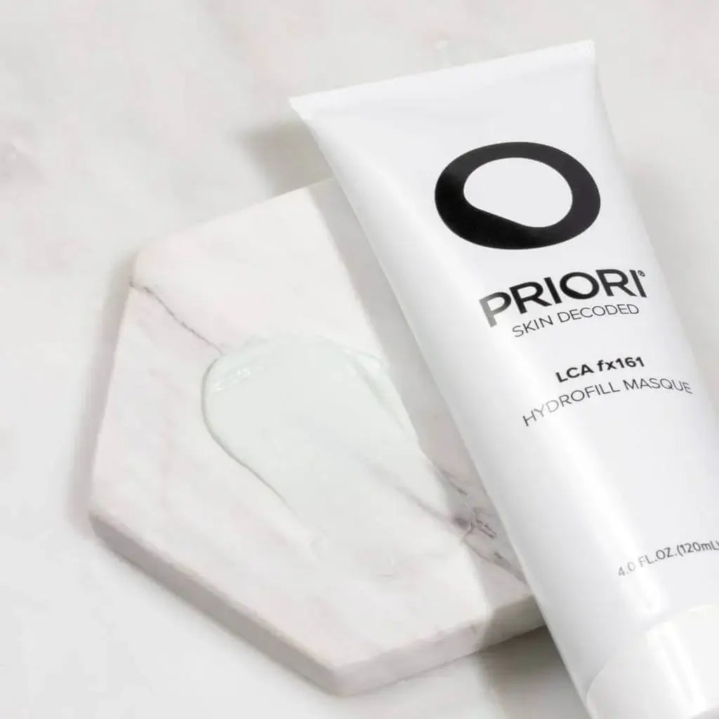 PRIORI LCA fx161 Hydrofill Masque tube on a marble surface with a small amount of product spilled.