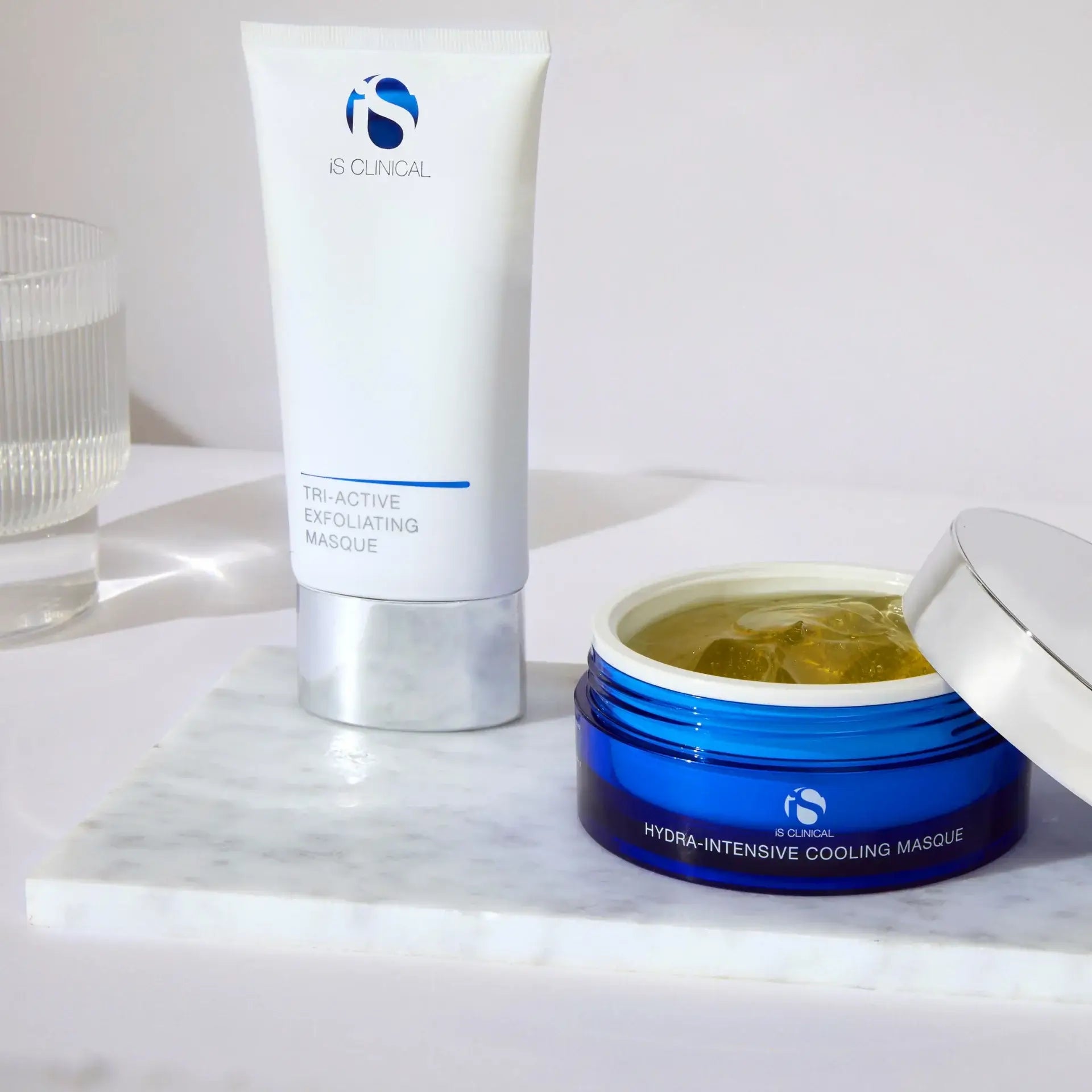 iS Clinical Smooth & Soothe Clinical Facial products: Tri-Active Exfoliating Masque and Hydra-Intensive Cooling Masque on marble