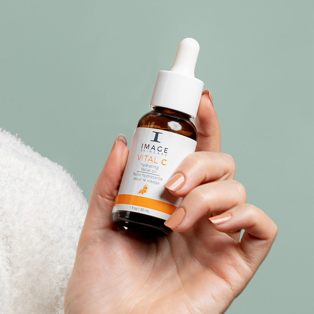 IMAGE Skincare VITAL C Hydrating Facial Oil bottle held in hand