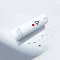 Dr LEVY Intense Cell Booster Serum bottle with drops of serum on a light background.