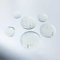 Dr LEVY Intense Cell Booster Serum droplets showcasing its lightweight texture and hydrating properties.