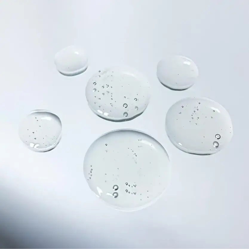 Dr LEVY Intense Cell Booster Serum droplets showcasing its lightweight texture and hydrating properties.