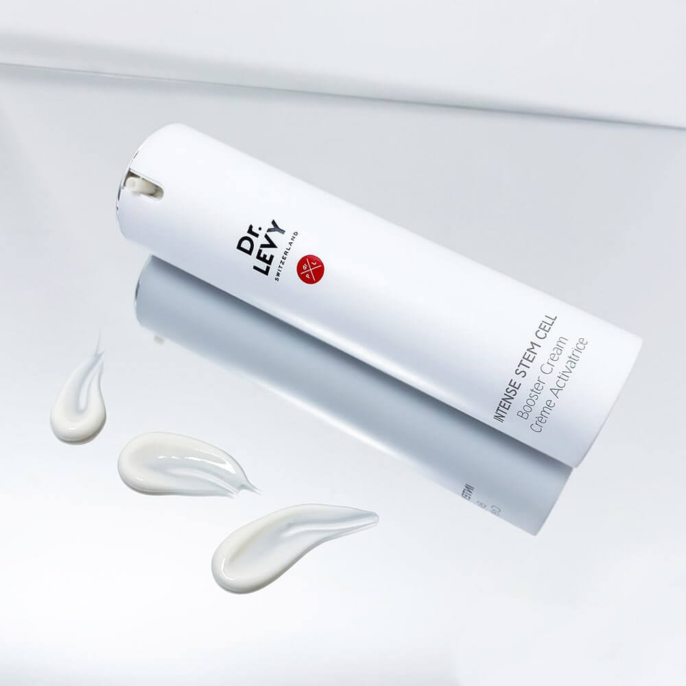 Dr LEVY Intense Stem Cell Booster Cream in white tube with cream swatches on reflective surface.
