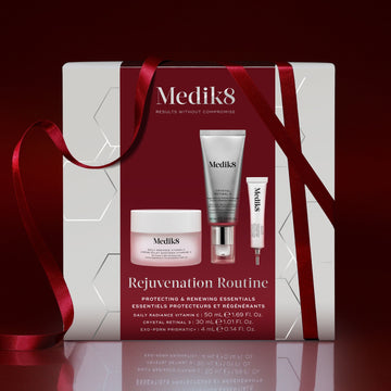 Medik8 Rejuvenation Routine festive gift box wrapped in red ribbon