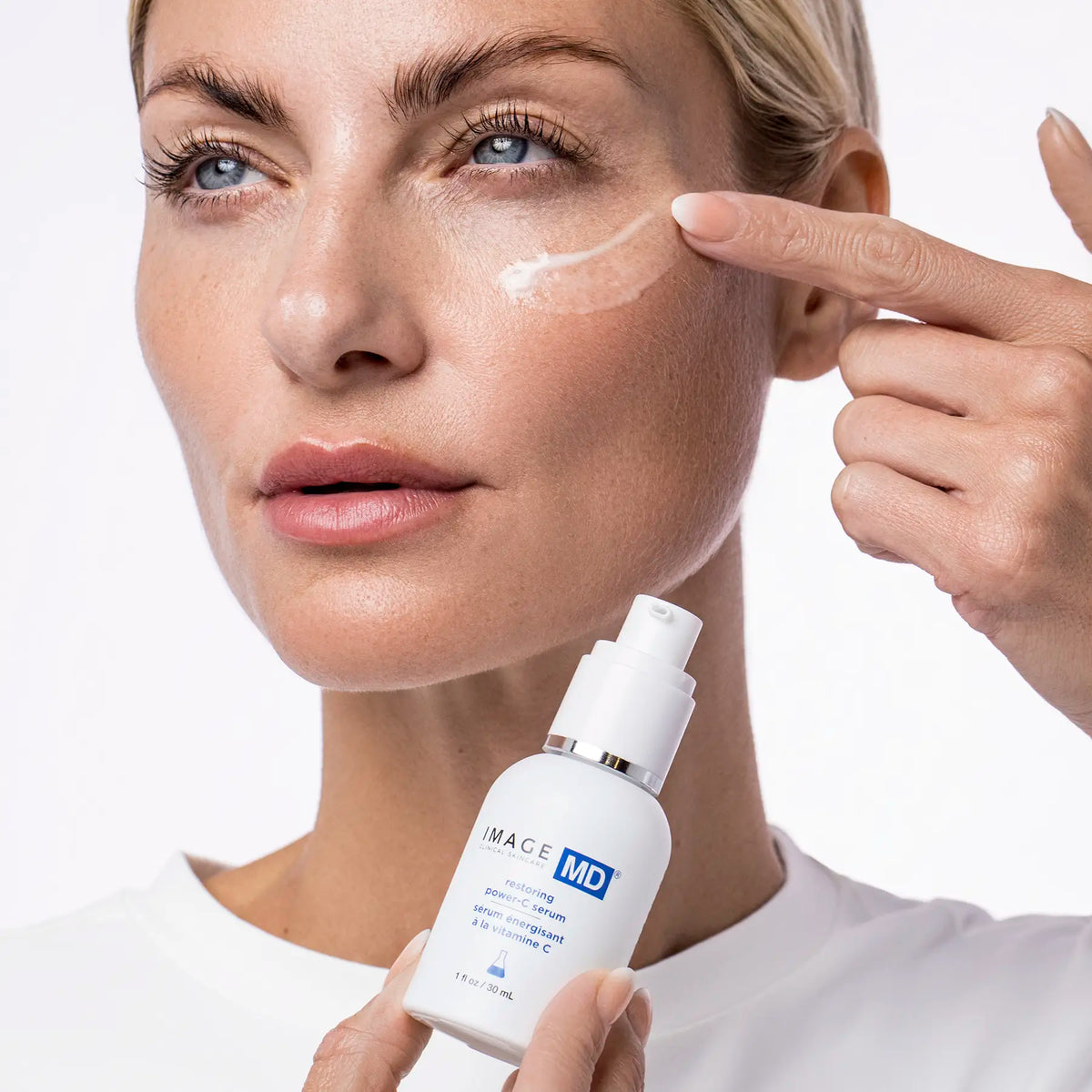IMAGE Skincare MD Restoring Power-C Serum being applied to the cheek by a model