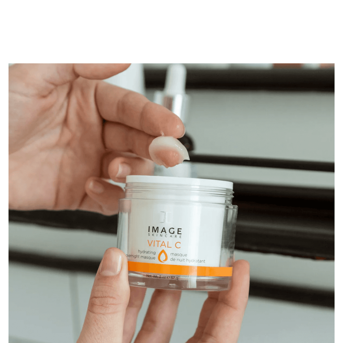 IMAGE Skincare VITAL C Hydrating Overnight Masque open jar held in hand with gel texture on fingertip