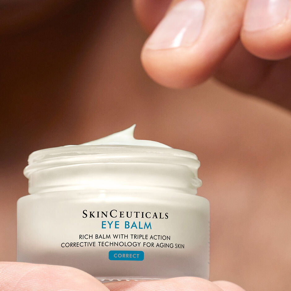 Open jar of SkinCeuticals Eye Balm held in hand