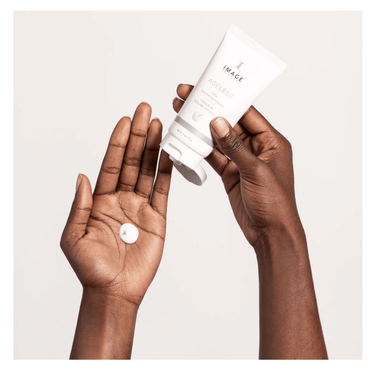 IMAGE Skincare AGELESS Total Resurfacing Masque held in hand with a dollop of the creamy exfoliating mask