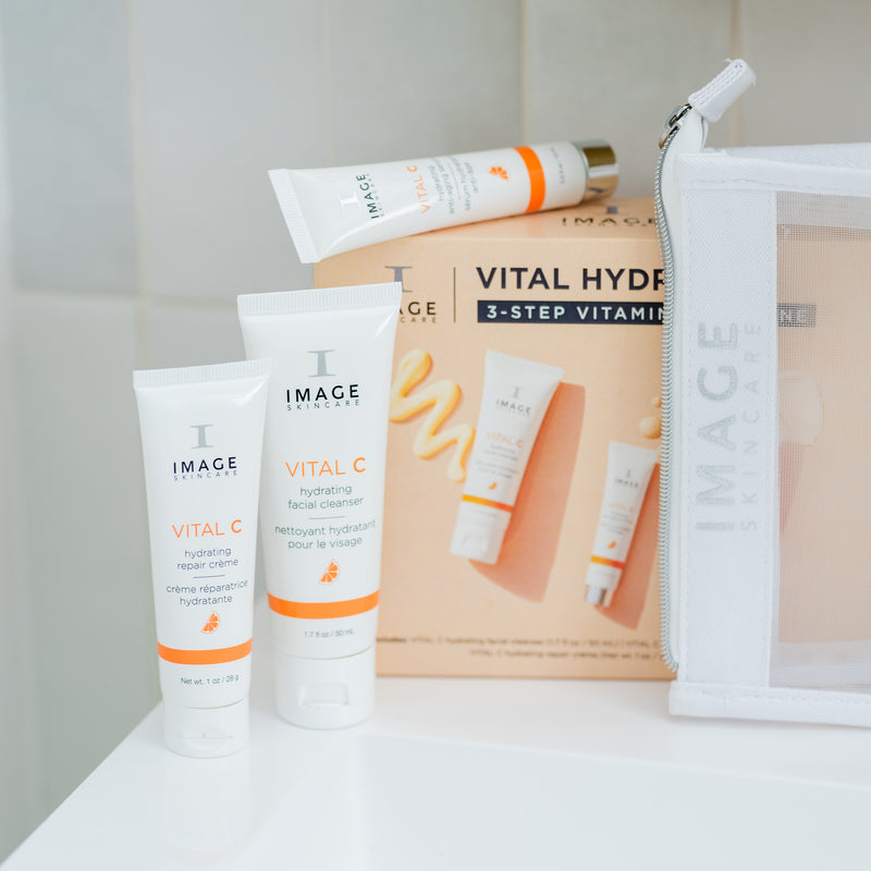 IMAGE Skincare VITAL HYDRATION 3-Step Vitamin C Routine products and cosmetic bag on a bathroom shelf